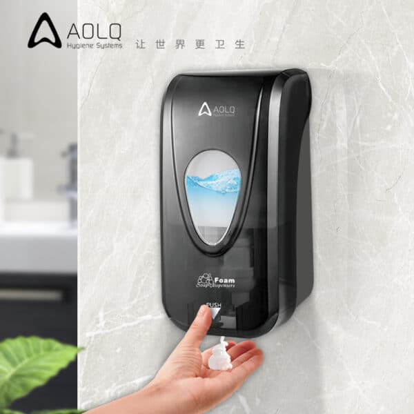 Wall mounted black transparent foam soap dispenser in use dispensing foam into ideal for public or commercial restrooms
