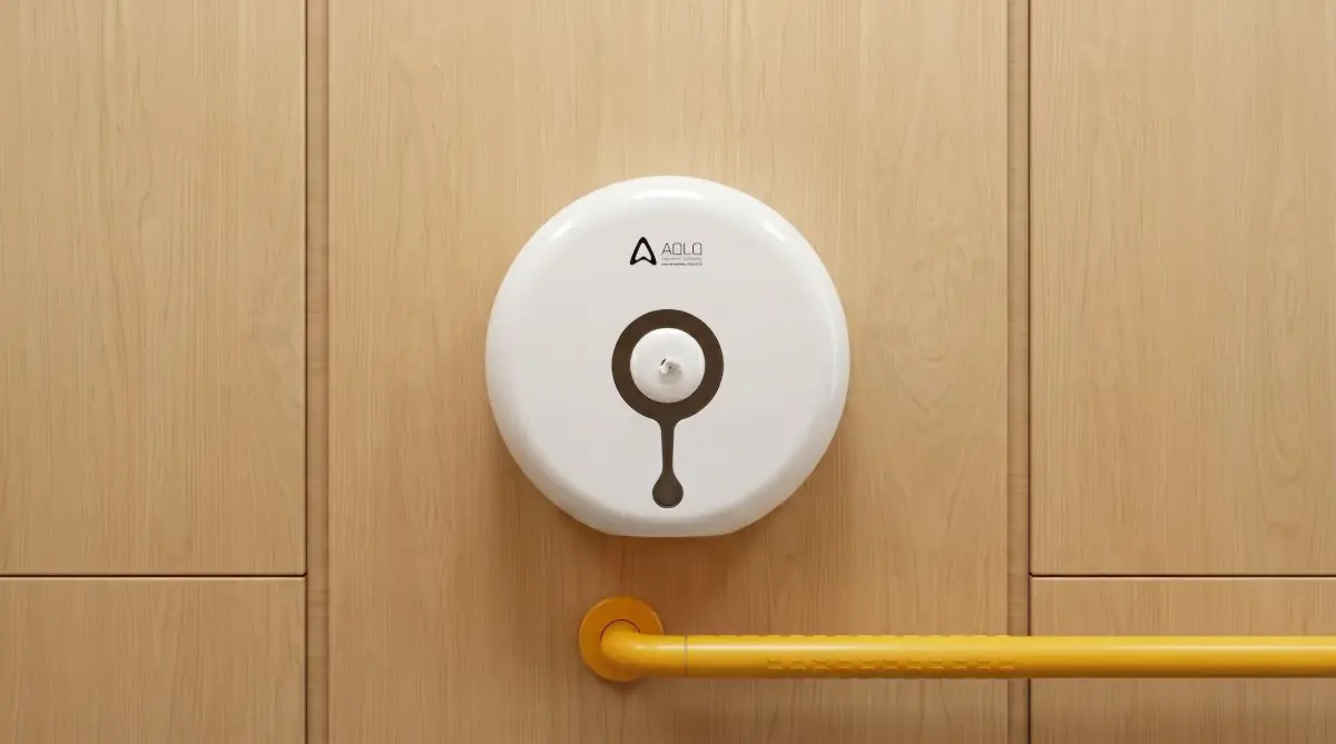 White Center Pull Tissue Dispenser in a commercial public restroom, installed on a wood wall with a grab bar.